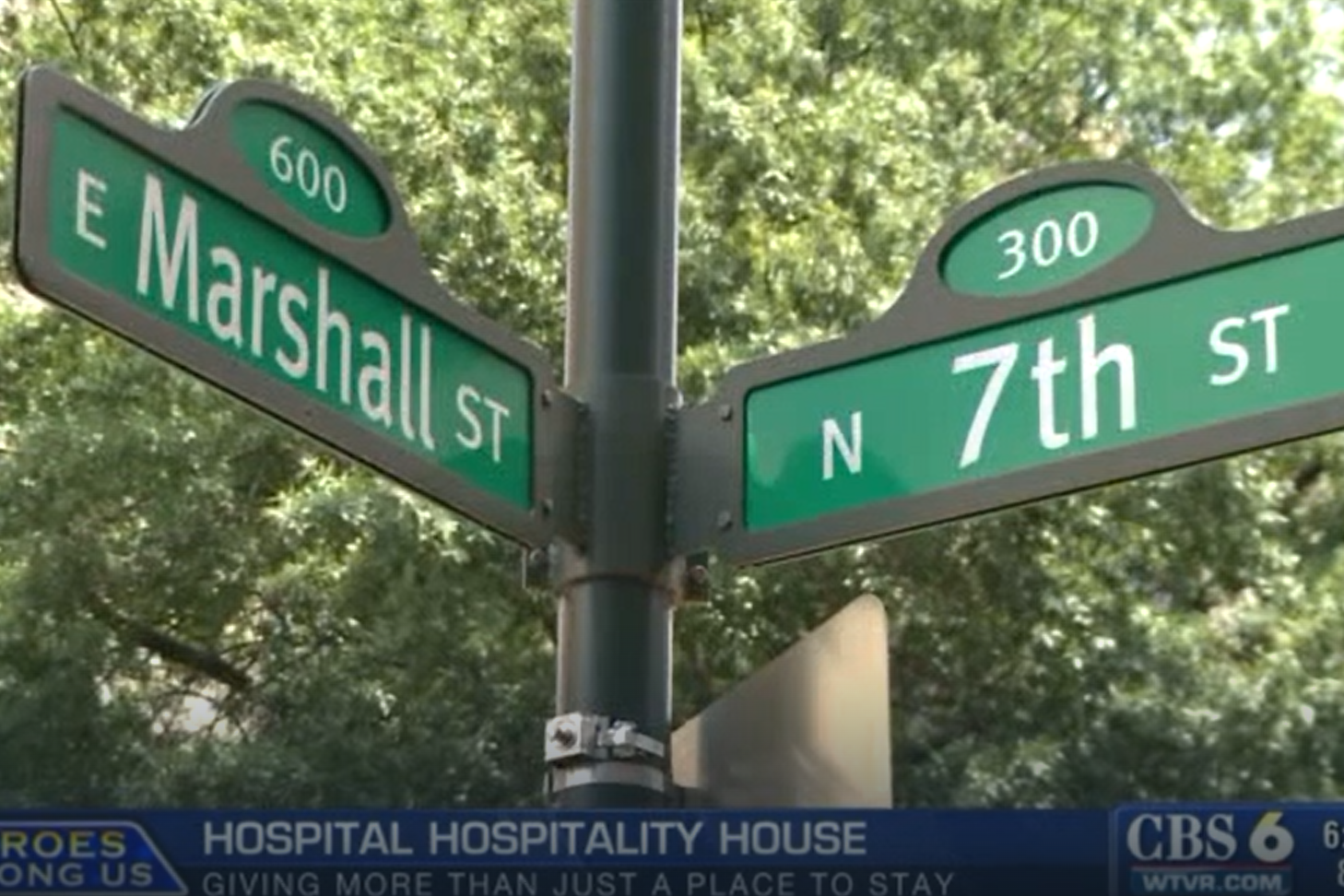 street signs for E Marshall St and N 7th St are photographed alongside the news headline 