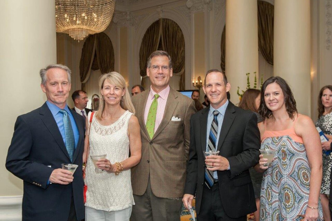 Five smiling adults pose at The Jefferson