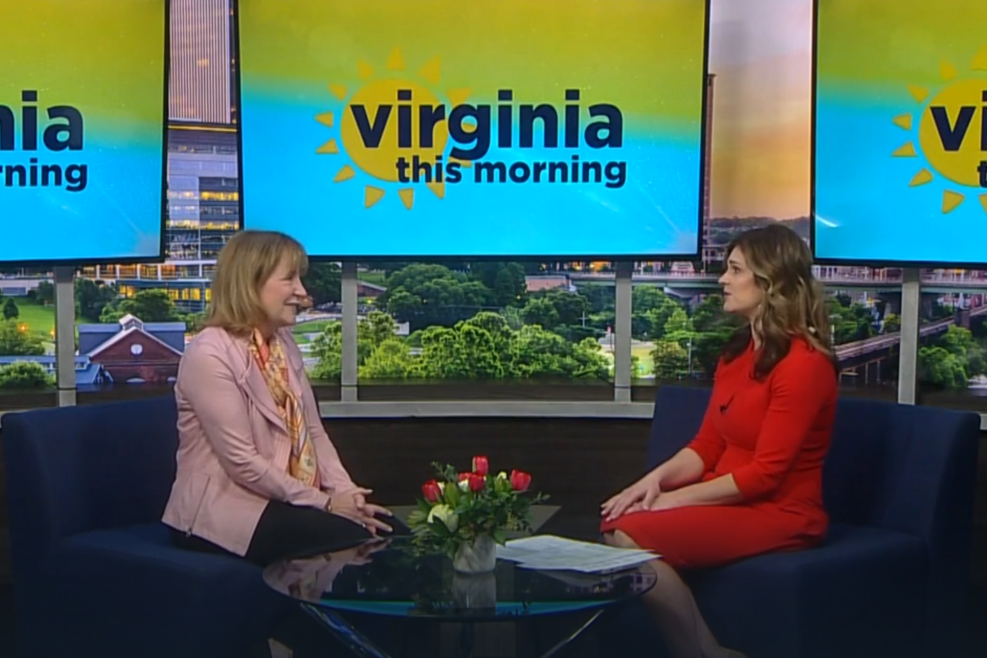 Two smiling individuals chat in a studio with 