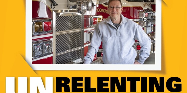 Photo of a smiling adult leaning against a firetruck with the words 