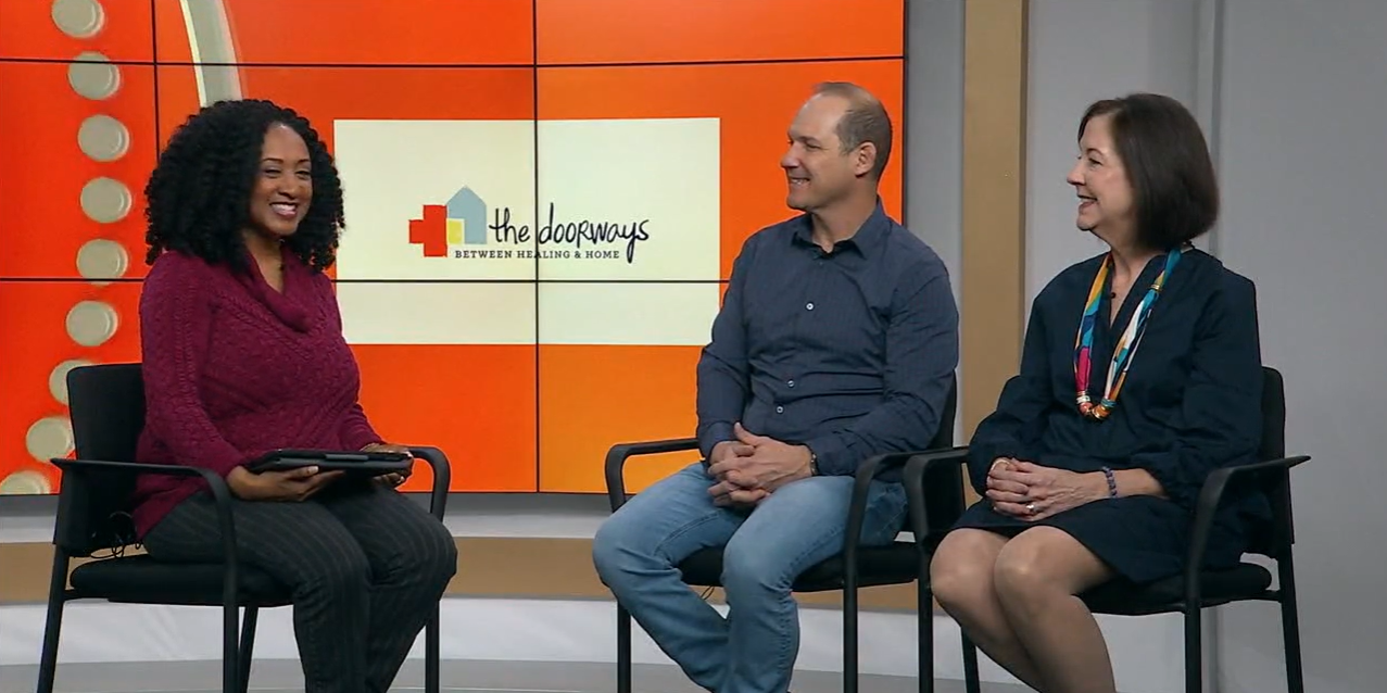 Three smiling adults sit in the W-R-I-C studio